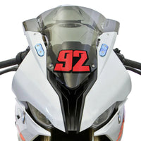 Personalized MC Motoparts racing number stickers in T21 solid color style on dirt bike or motorcycle, shown installed in the image.