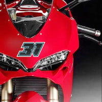 Three custom racing number stickers with gradient outline style for dirt bikes and motorcycles, installed on a vehicle.