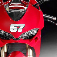 Custom racing number stickers from MC Motoparts, featuring G005 gradient style, shown applied on dirt bike decals in a 3-pack.