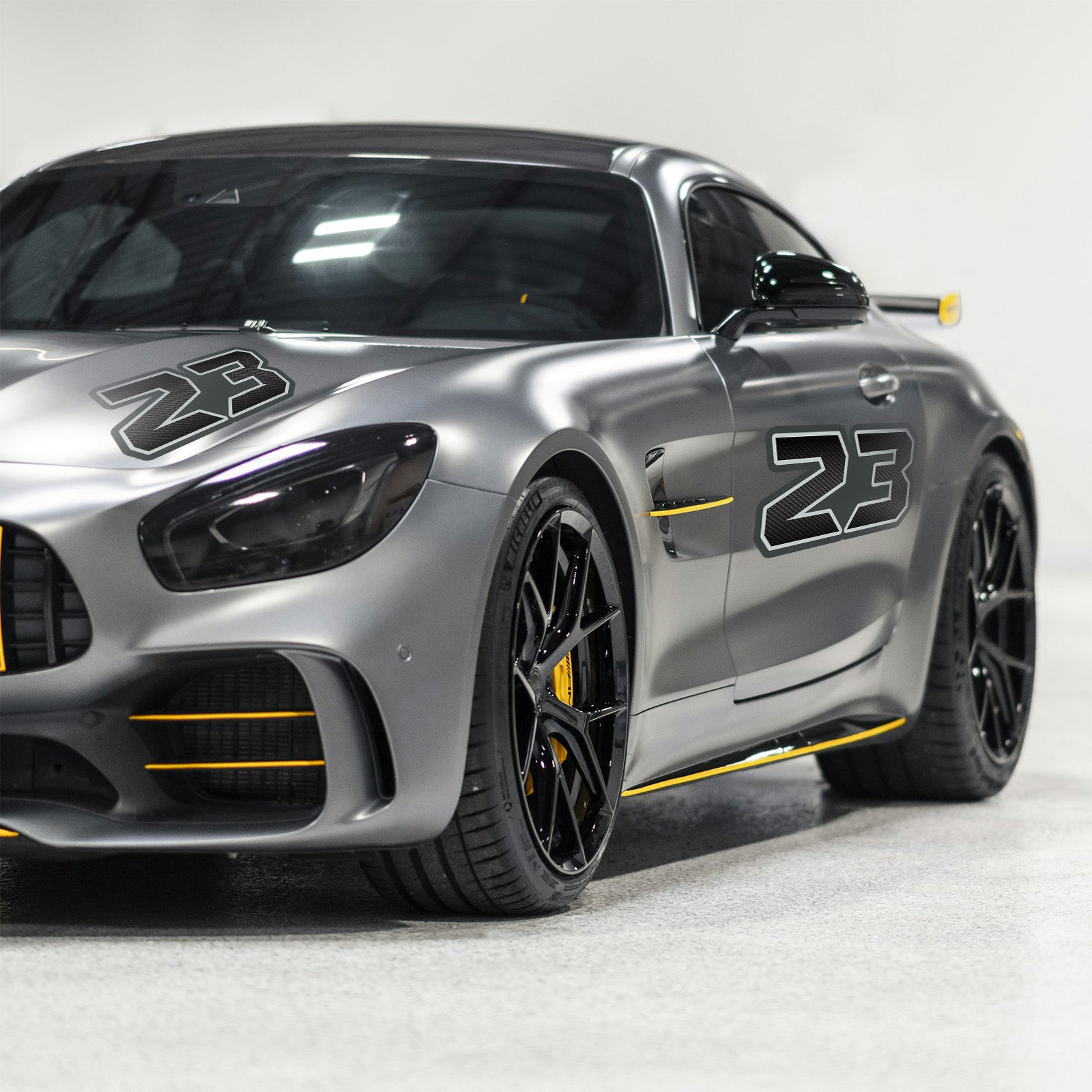 Custom Pro-Series G012 carbon fiber racing number and name decals on a motorcycle mockup, professional grade vinyl, 3-pack bundle by MC Motoparts.