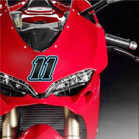 Custom Pro-Series G013 carbon fiber racing number and name decals on dirt bike, professional-grade vinyl, installed on motorcycle.