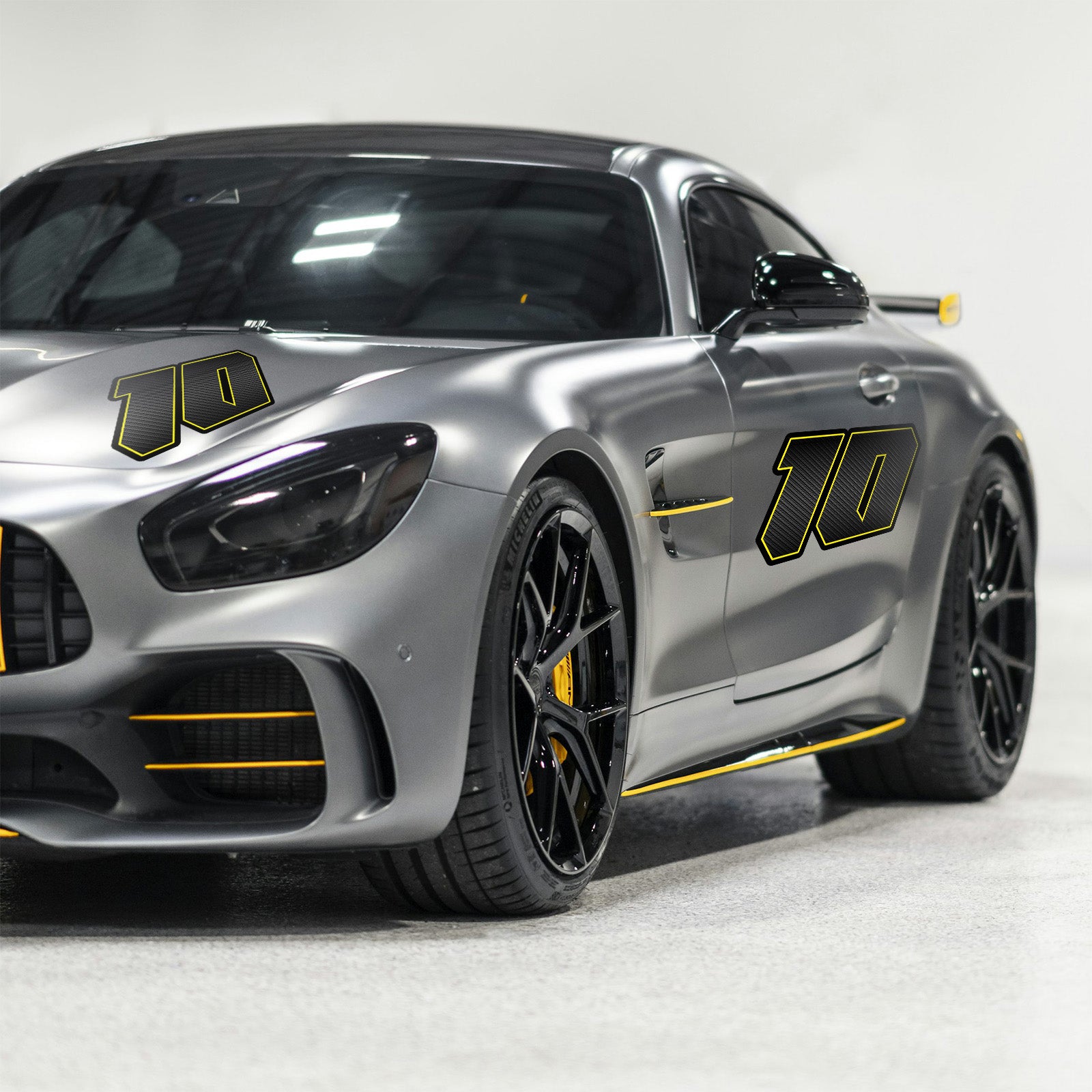 Magnet car mockup showing custom racing number stickers in G011 carbon fiber style for dirt bikes and motorcycles, 3-pack decals.